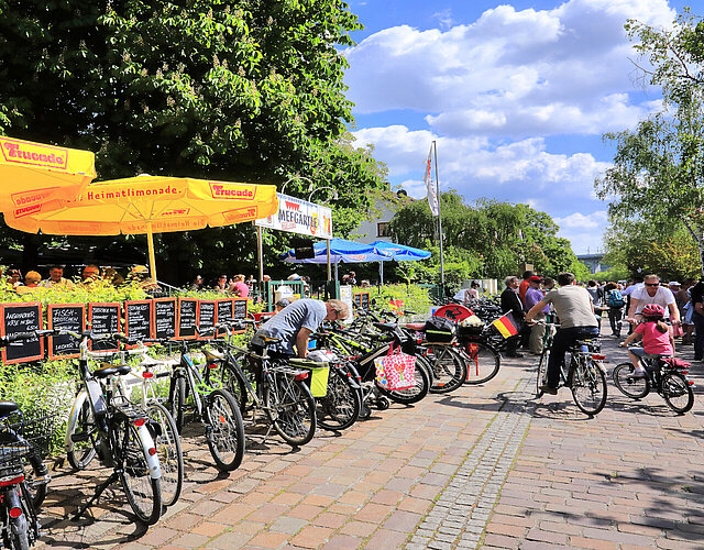 Fahrräder, die am Zaun des Biergartens an der Veitshöchheimer Mainlände angelehnt sind.